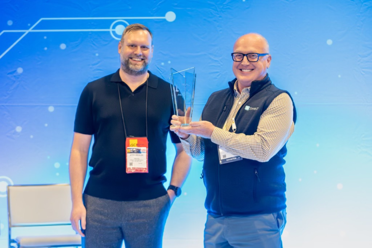 SWEAR CEO Jason Crawforth accepting the Judges’ Choice Award at ISC West 2024, standing alongside a conference representative, celebrating innovation in digital content authentication.